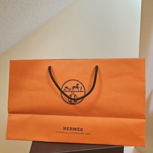 A Set of 3 Hermès Orange Shopping Bags